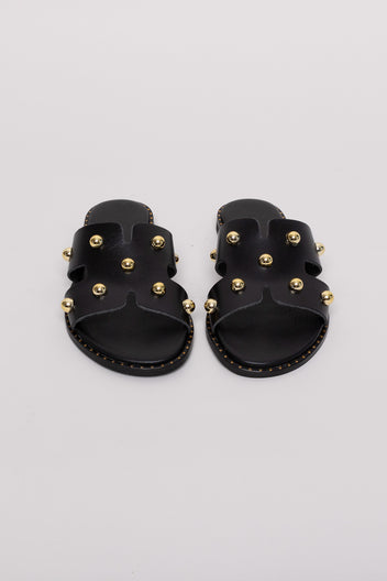 Black leather studded slide sandals with gold studs, pair view on grey background