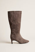 Single taupe suede knee-high boot with a slim kitten heel and pointed toe, side view of the smooth tall shaft