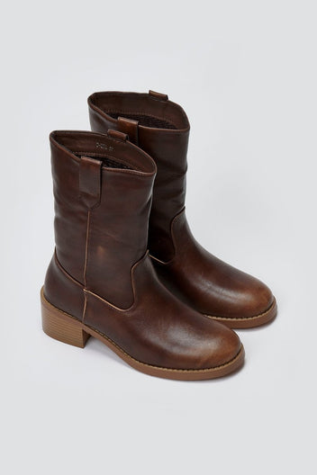 Dark brown leather mid-calf boots with block heel and side panel, pair in angled view on a model's legs in studio light