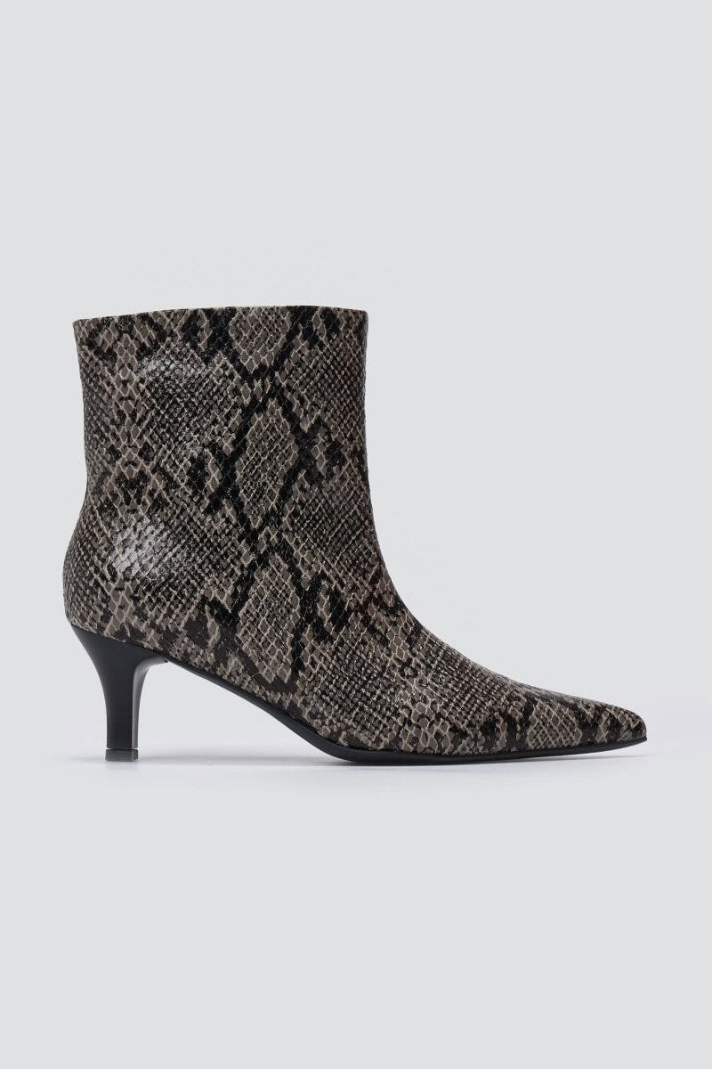 Grey snake-embossed leather ankle boot with pointed toe and kitten heel, side view on a light grey background