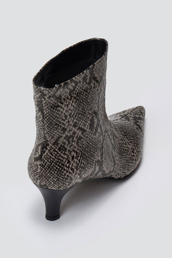 Grey snake-embossed leather ankle boot with pointed toe and kitten heel, angled view on a light grey background