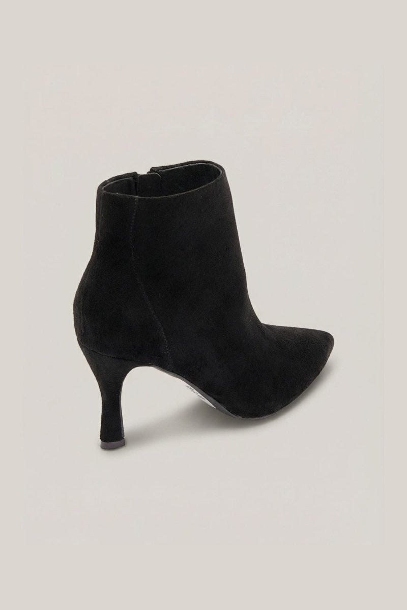 Black suede pointed-toe ankle boot with stiletto heel and side zip, angled view on a light grey background