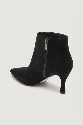 Black suede pointed-toe ankle boot with stiletto heel and side zip, angled side view on a light grey background