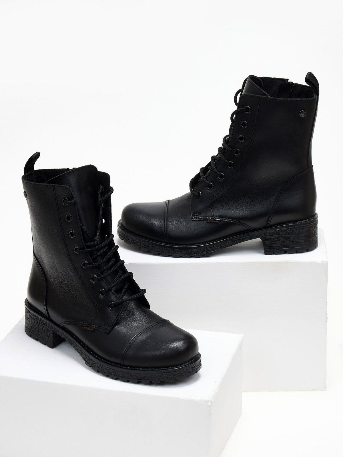 Black leather lace-up ankle boots with cap toe and block heel, pair in angled view on a white plinth