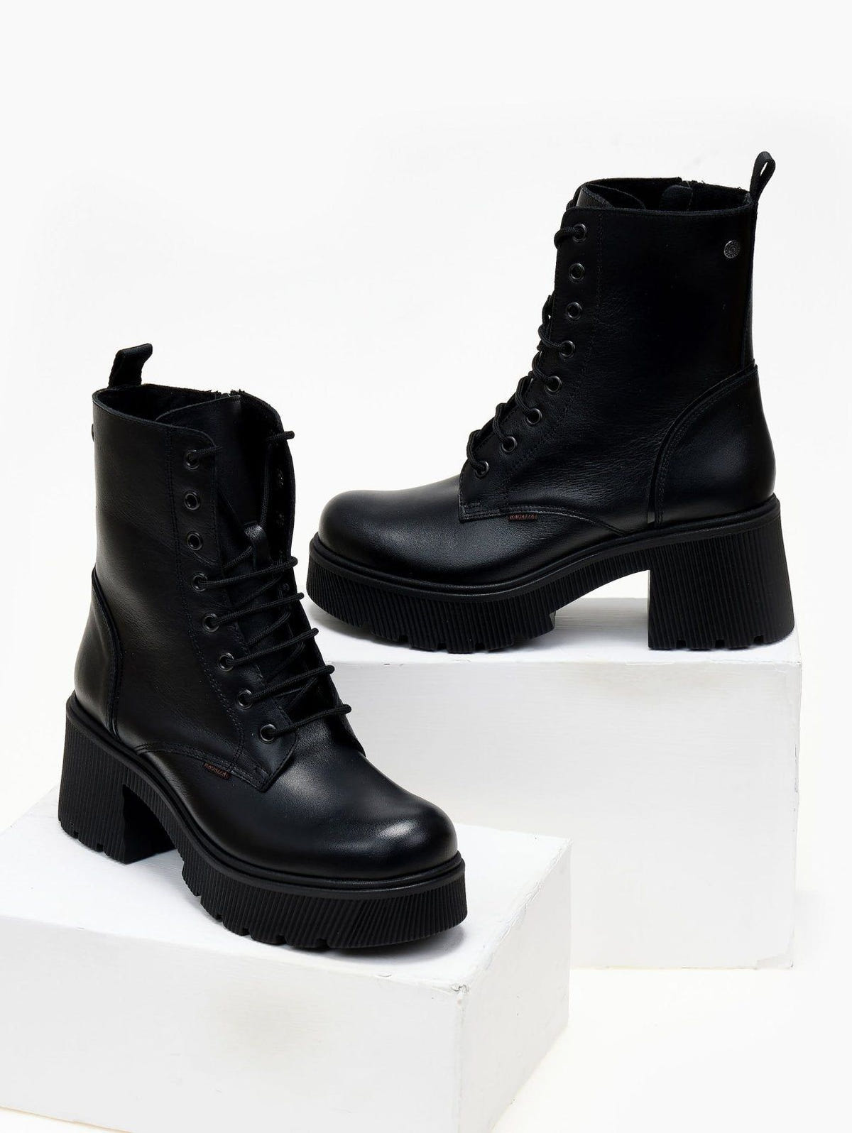 Black leather lace-up platform ankle boots with block heel, pair in angled view on a white plinth
