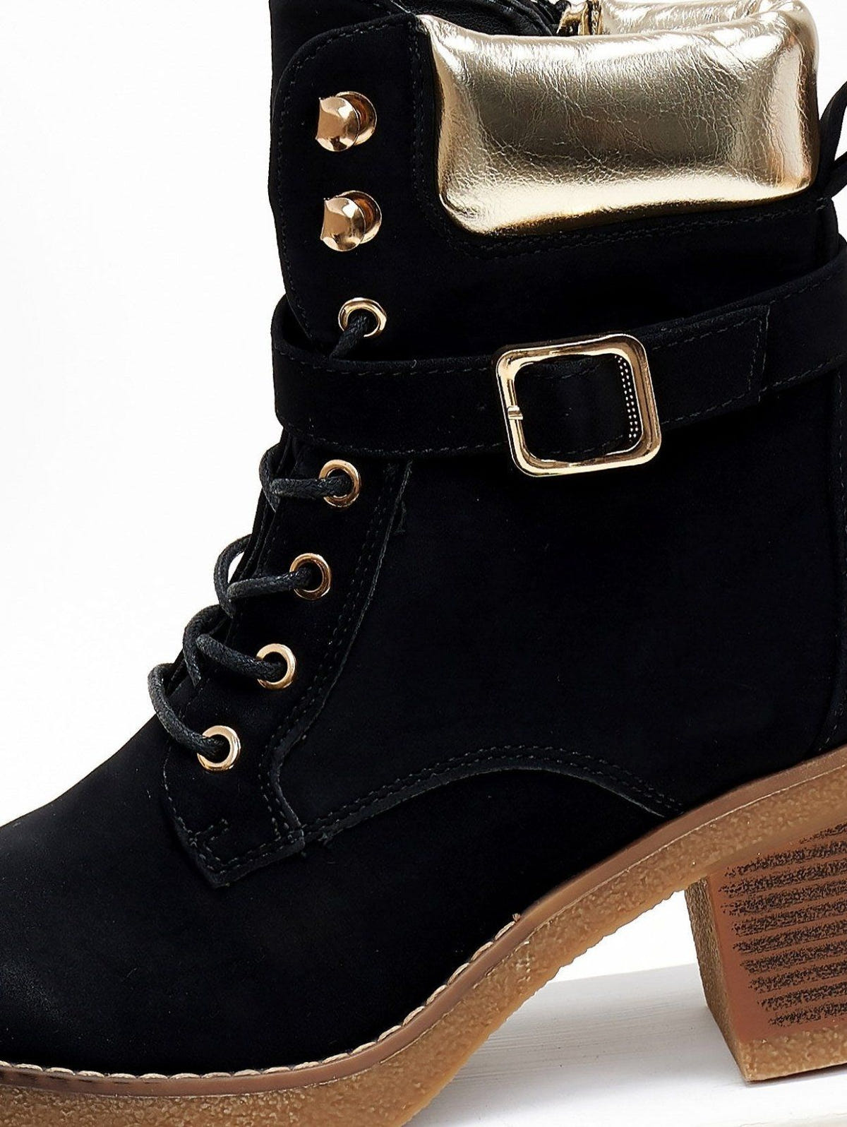 Black nubuck lace-up boot with gold padded collar, gold buckle strap and eyelets, close-up of lacing detail
