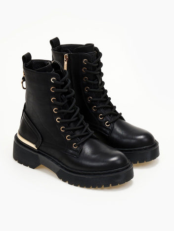 Pair of black lace-up leather boots with gold eyelets, gold trim and chunky sole on a white background