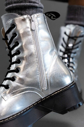 Close-up of silver metallic lace-up boot with black laces, side zip and chunky sole