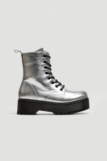 Silver metallic lace-up boot with black chunky sole, side view on light grey background