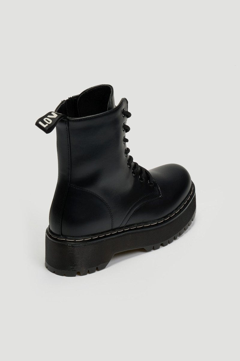 Black leather lace-up boot with pull tab and chunky black platform sole, side view on grey background