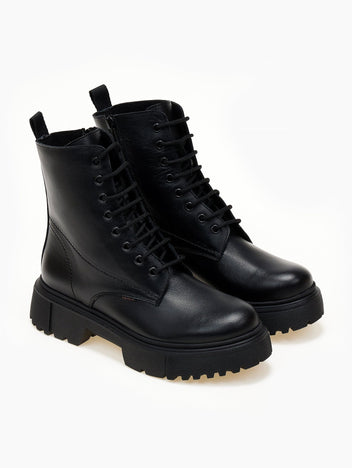 Black leather lace-up ankle boots with cap toe and lug sole, pair in angled view on a light background