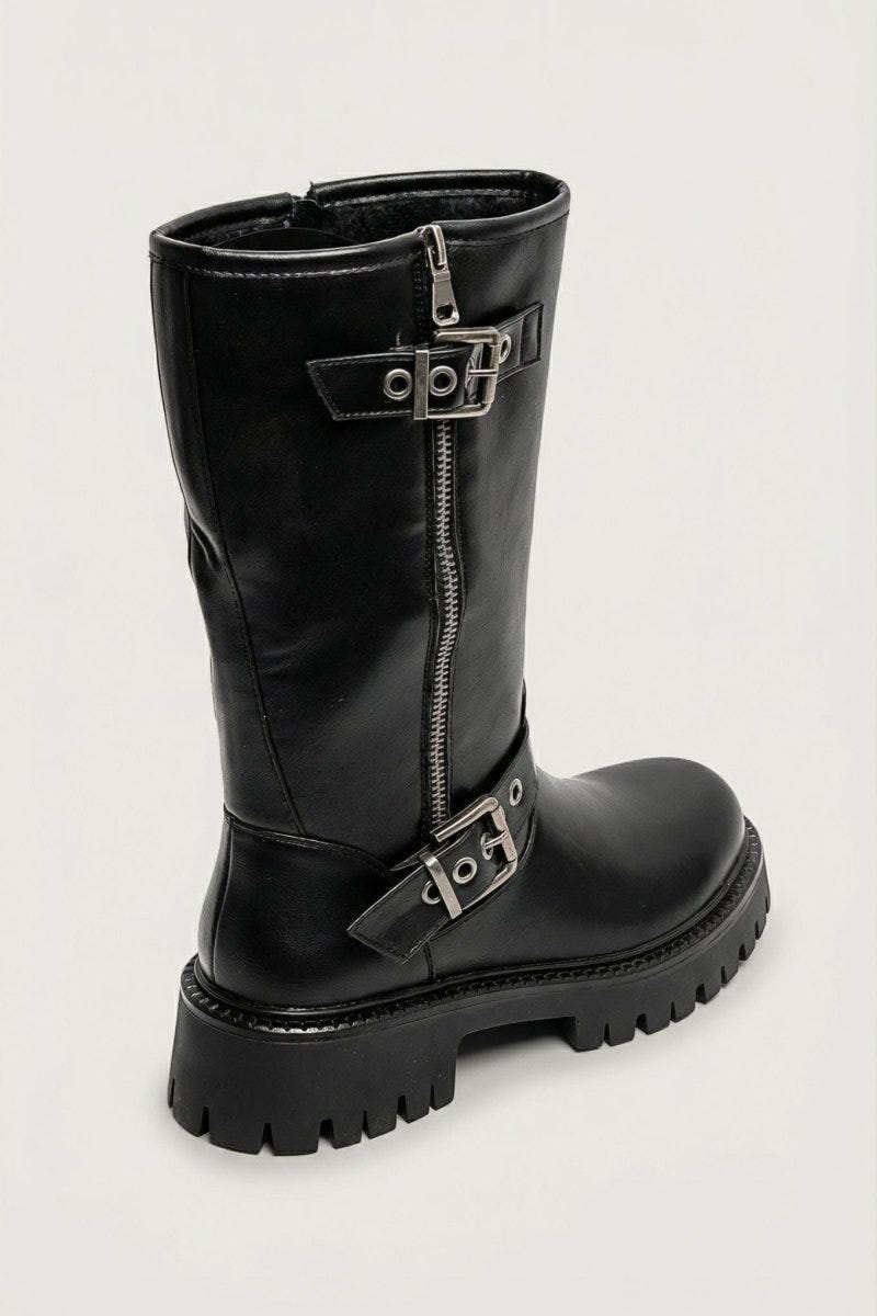 Black leather knee-high boot with buckle straps and chunky sole, side view on light grey background