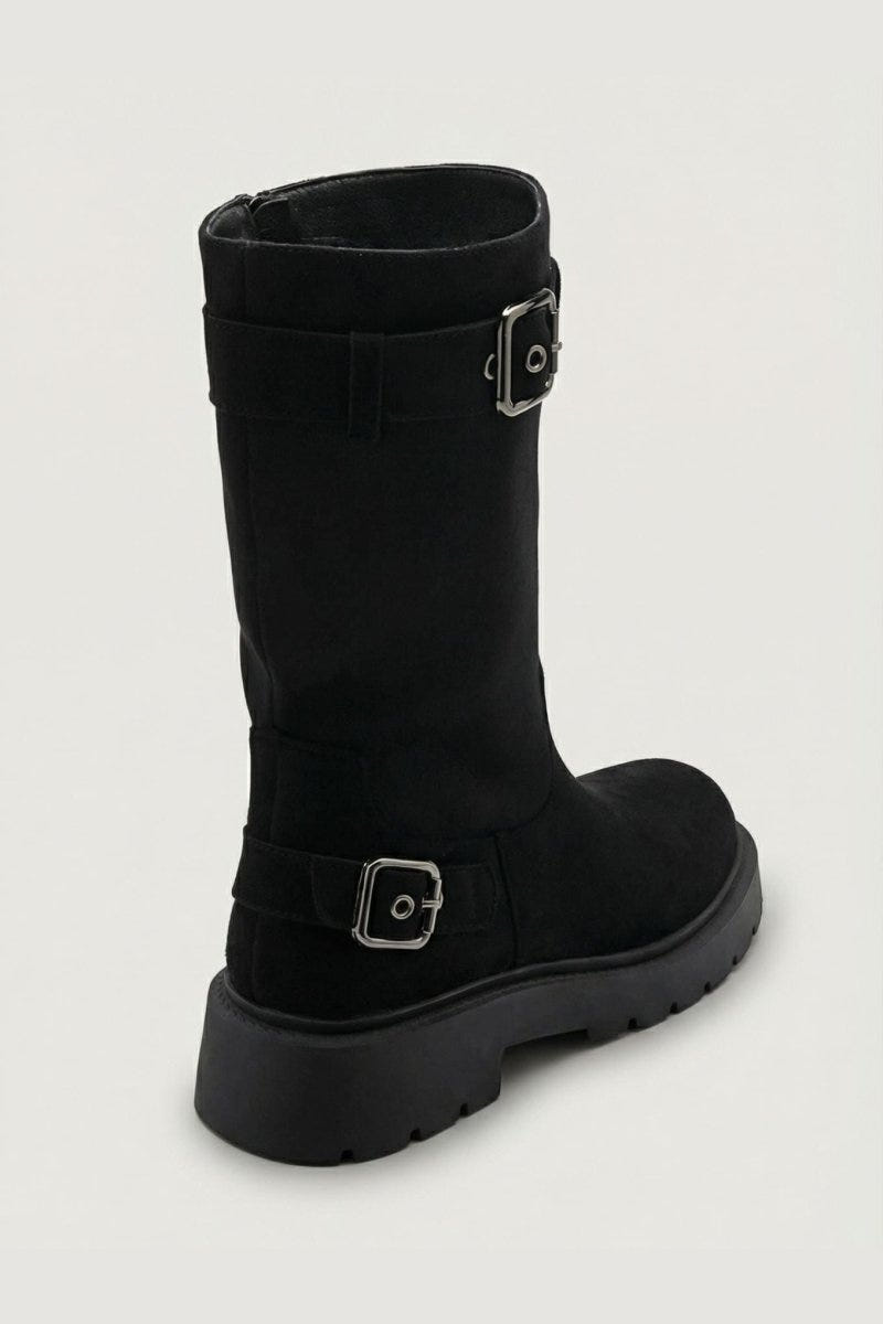 Black suede knee-high boot with buckle straps and chunky black sole, side view on light grey background