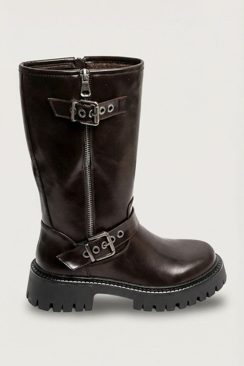 Brown glossy leather knee-high boot with buckle straps and lug sole, angled view on light grey background