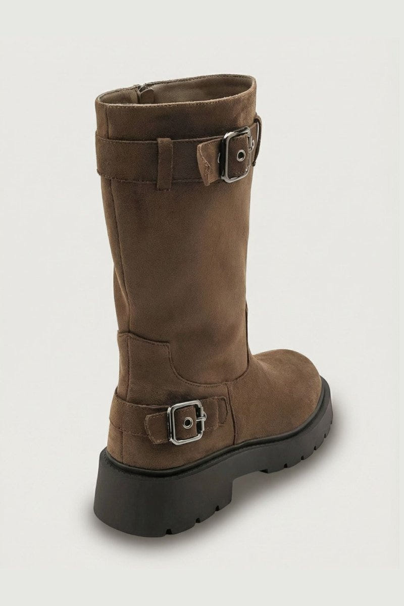 Brown suede knee-high boot with buckle straps and chunky sole, angled view on light grey background