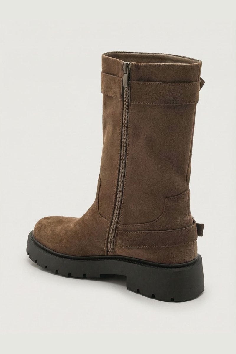 Brown suede knee-high boot with buckle strap and side zip, side view on light grey background