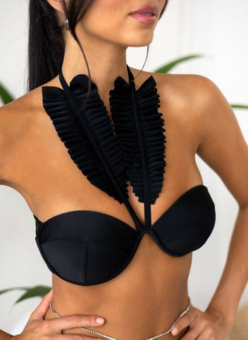 Close-up of black underwire bikini top with feather neck halter and chain detail, front view