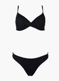Black underwire bikini top and black bikini bottom, laid flat on white background