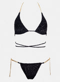 Black triangle bikini top with wrap straps and gold chain side details, matching black bikini bottom laid flat on white