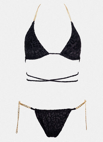 Black triangle bikini top with wrap straps and gold chain side details, matching black bikini bottom laid flat on white