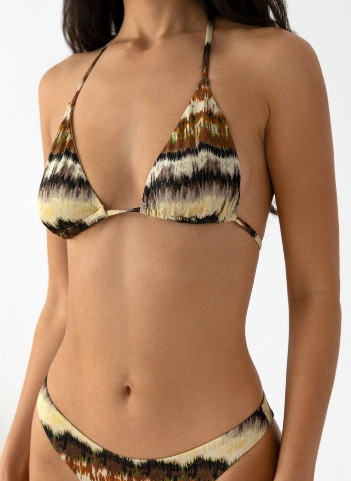 Close-up of model wearing brown and cream wave print triangle bikini top and matching bikini bottom, front view