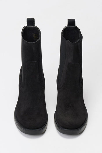 Black suede Chelsea ankle boots with block heel and elastic side panels, front view on light backdrop