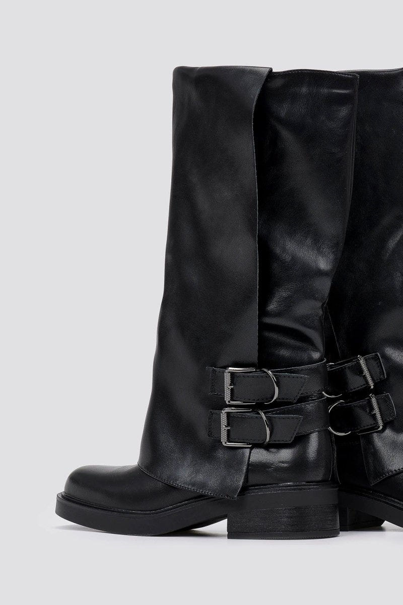 Black leather knee-high boot with two buckle straps at the side and round toe, front view on a light grey background