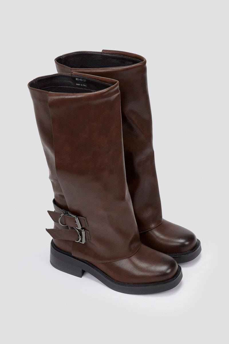 Pair of brown leather knee-high boots with buckle straps and rounded toes, angled view on a light grey background