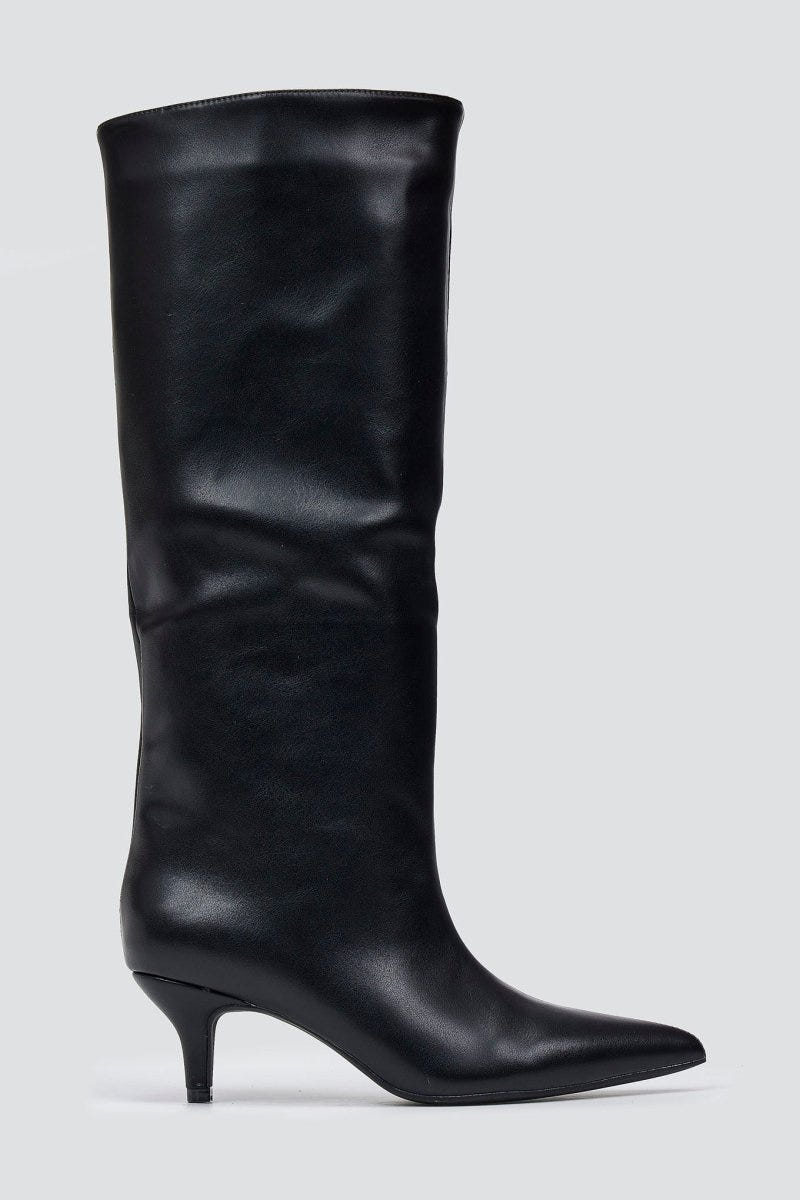 Black leather knee-high pointed toe boot with slouchy shaft and kitten heel, side view on a light grey background