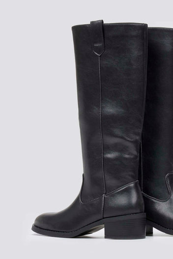 Black leather knee-high boot with round toe, chunky block heel and pull tab at the back, side view on light grey