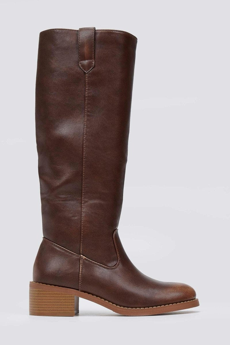 Dark brown leather knee-high boot with round toe and tan block heel, side view on a light grey background