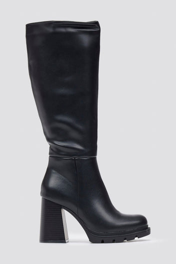 Black leather knee-high boot with block heel and smooth shaft, side view on a light grey background