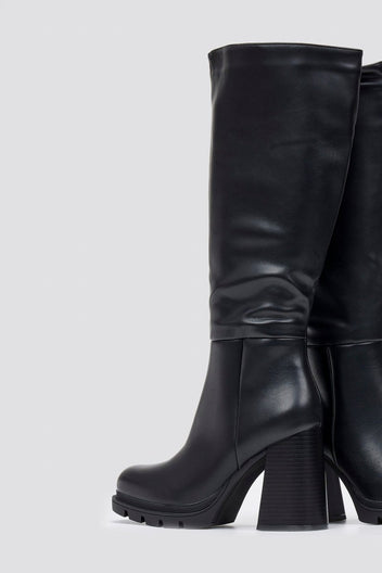 Black leather knee-high boot with block heel and smooth shaft, angled view on a light grey background