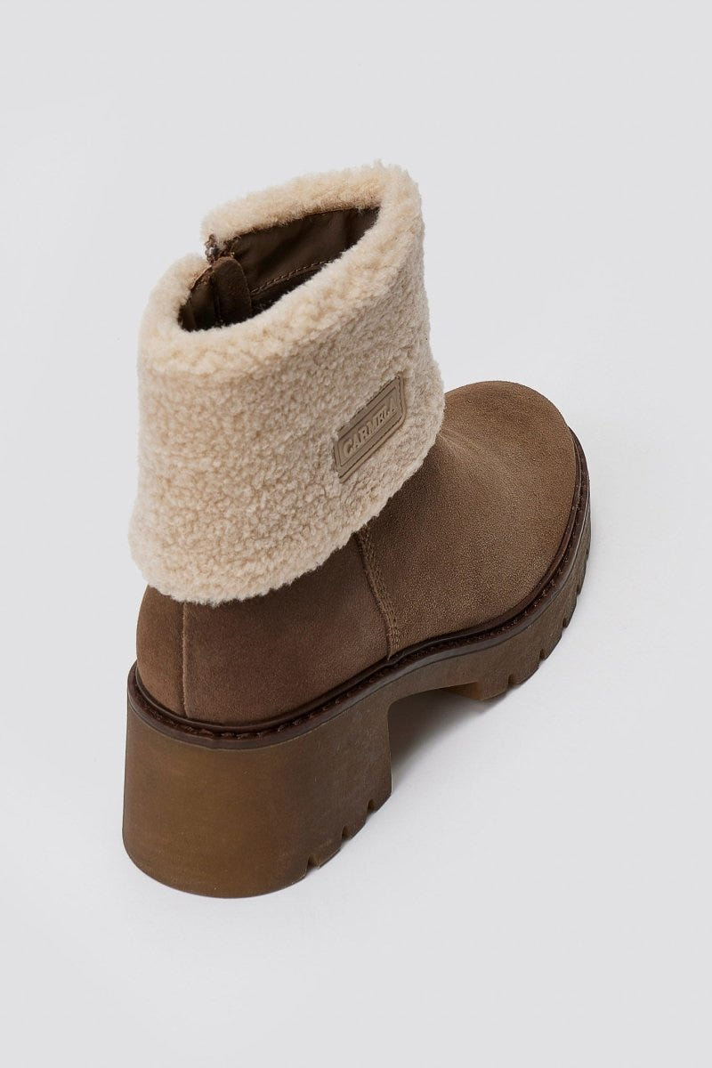Taupe suede shearling-cuff ankle boot with block heel and lug sole, side view on a light grey background