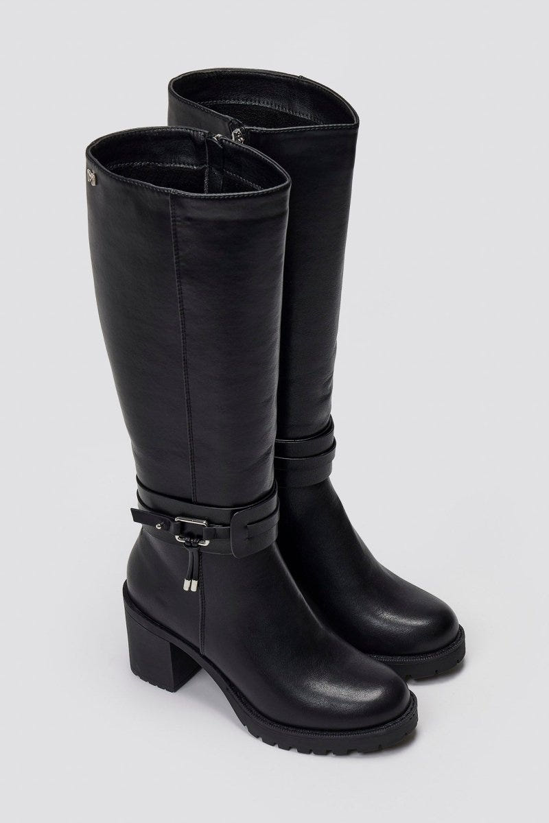 Pair of black leather knee-high block heel boots with buckle strap and round toes, angled view on a light grey background