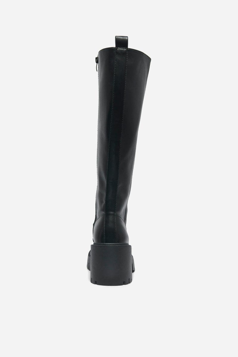 Black leather knee-high boot with chunky block heel and pull tab at the back, rear view on a light grey background