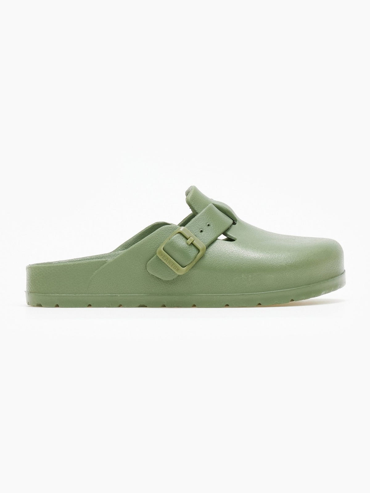 Sage green rubber clog with buckle strap and rounded toe, side view on a white background