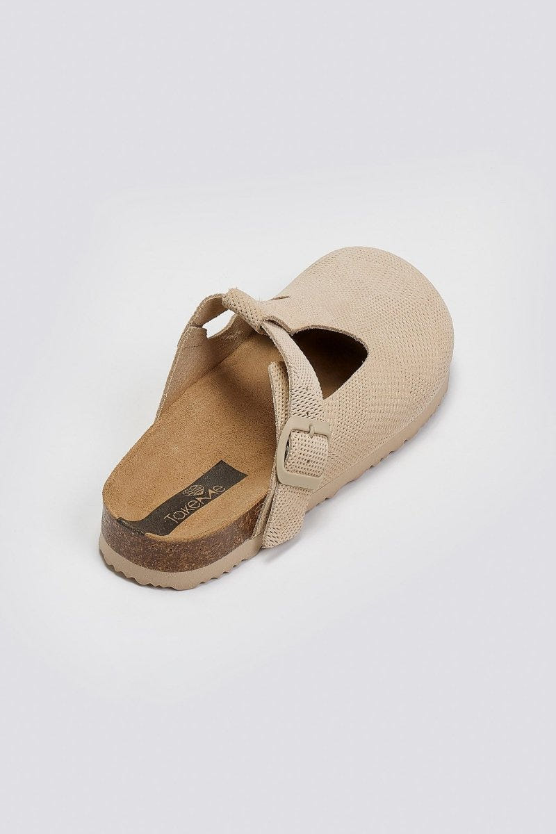 Beige woven clog with T-strap and cork footbed, angled view on a light grey background
