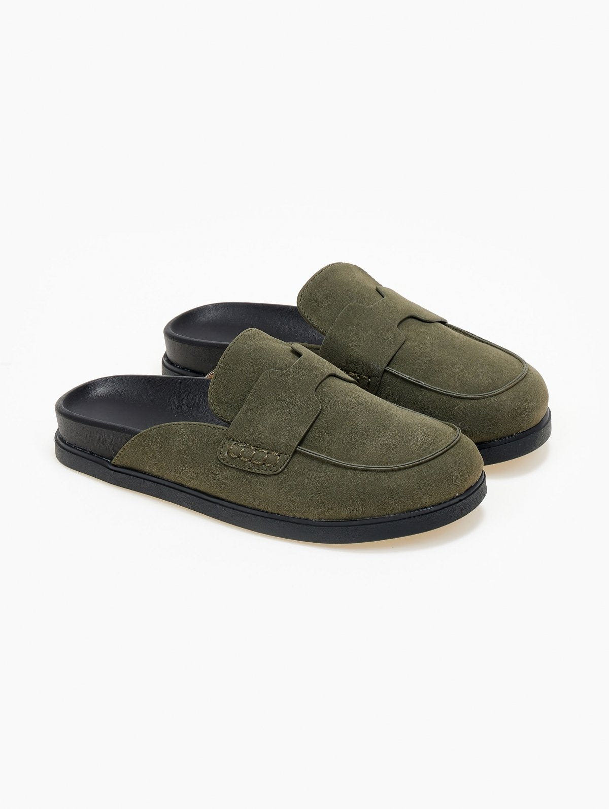 Pair of olive green suede loafer-style mules with black rubber soles, angled view on a white background