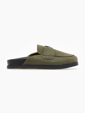 Olive green suede loafer-style mule with black rubber sole, side view on a white background