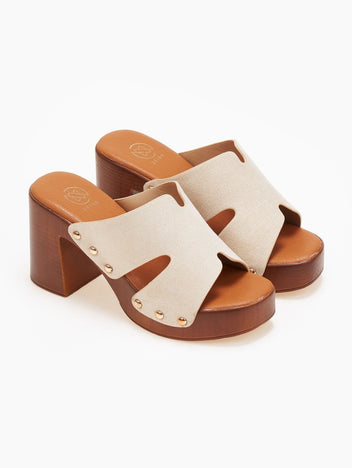 Pair of cream suede block heel slides with tan wooden-look platform, overhead angled view on a white background