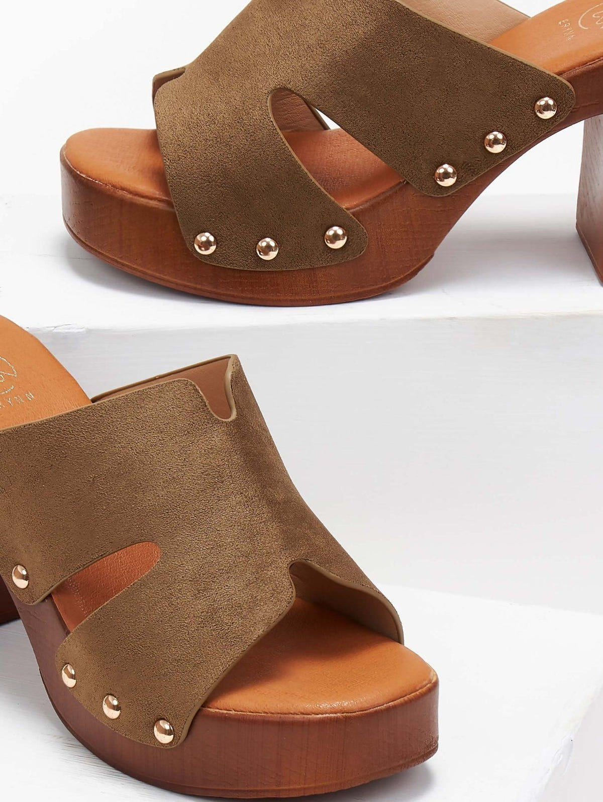 Close-up of olive suede block heel slide with gold studs and wooden-look platform, angled view on a white background