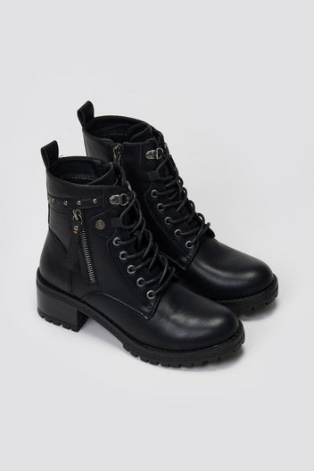 Pair of black leather lace-up ankle boots with chunky block heels, side studs and buckle detail, angled view on light grey