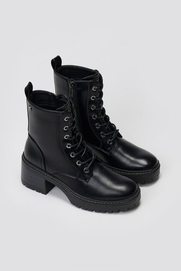 Pair of black leather lace-up ankle boots with chunky lug soles, angled view on a light grey background