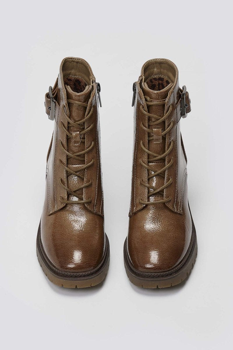 Pair of brown leather lace-up ankle boots with buckle straps and block heels, overhead view on a light grey background