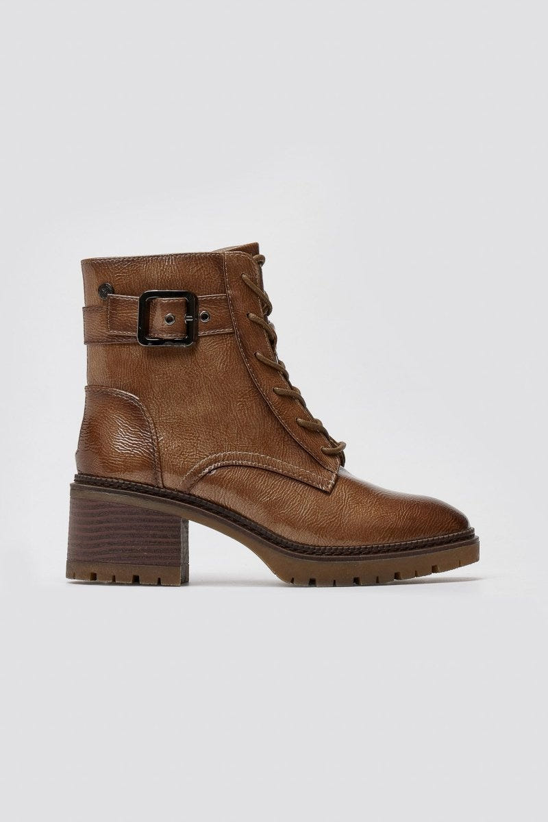 Brown leather lace-up ankle boot with buckle strap, block heel and lug sole, side view on a light grey background
