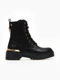 Black lace-up ankle boot with gold eyelets, gold metal trim and chunky black sole on a white background