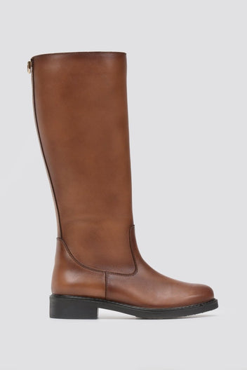 Cognac brown leather knee-high riding boot with flat sole and smooth shaft, side view on a light grey background