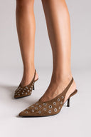 Brown pointed-toe slingback heels with studded details on a light gray background