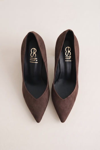 Top view of brown suede pointed-toe pumps showing narrow tapered toes and padded insole